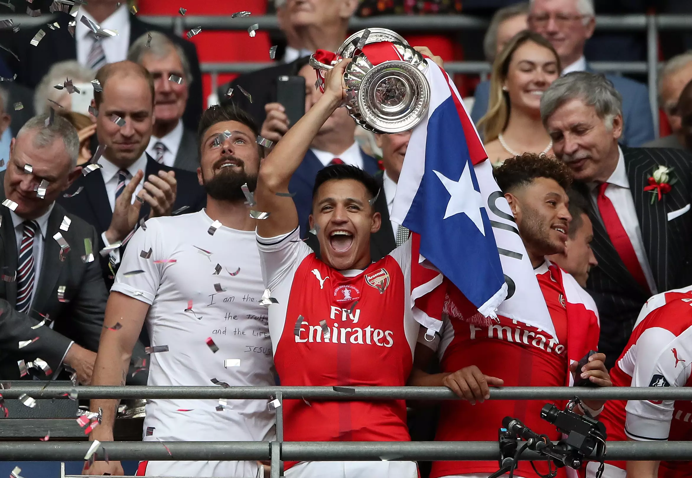 Sanchez holds aloft the FA Cup, last season. Image: PA
