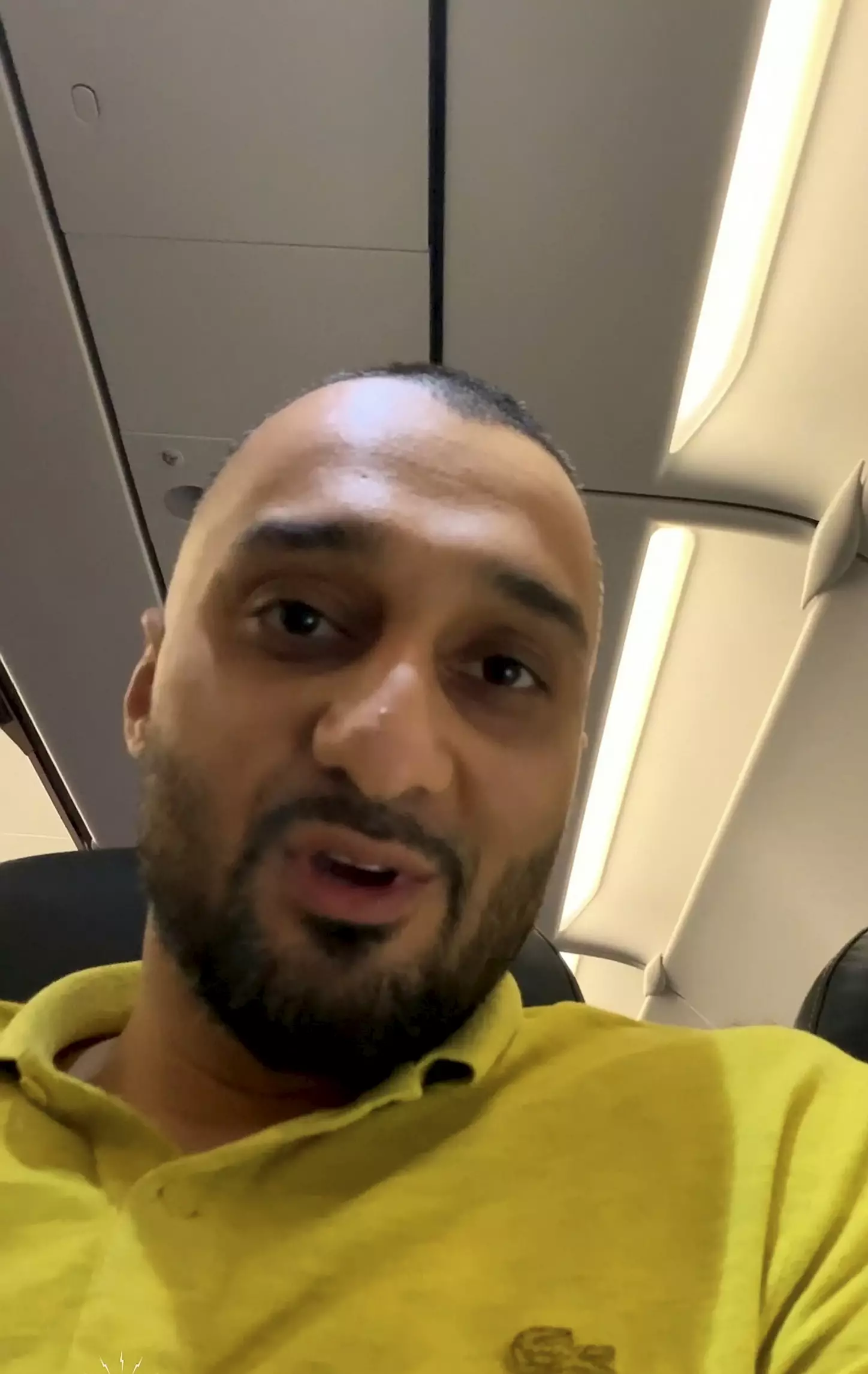 Video grab of Adil as he was sat on the plane.