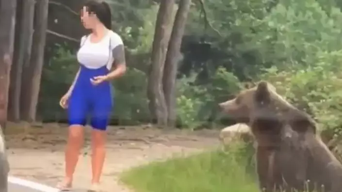 Bear Lunges At Woman Trying To Take Photograph Next To It