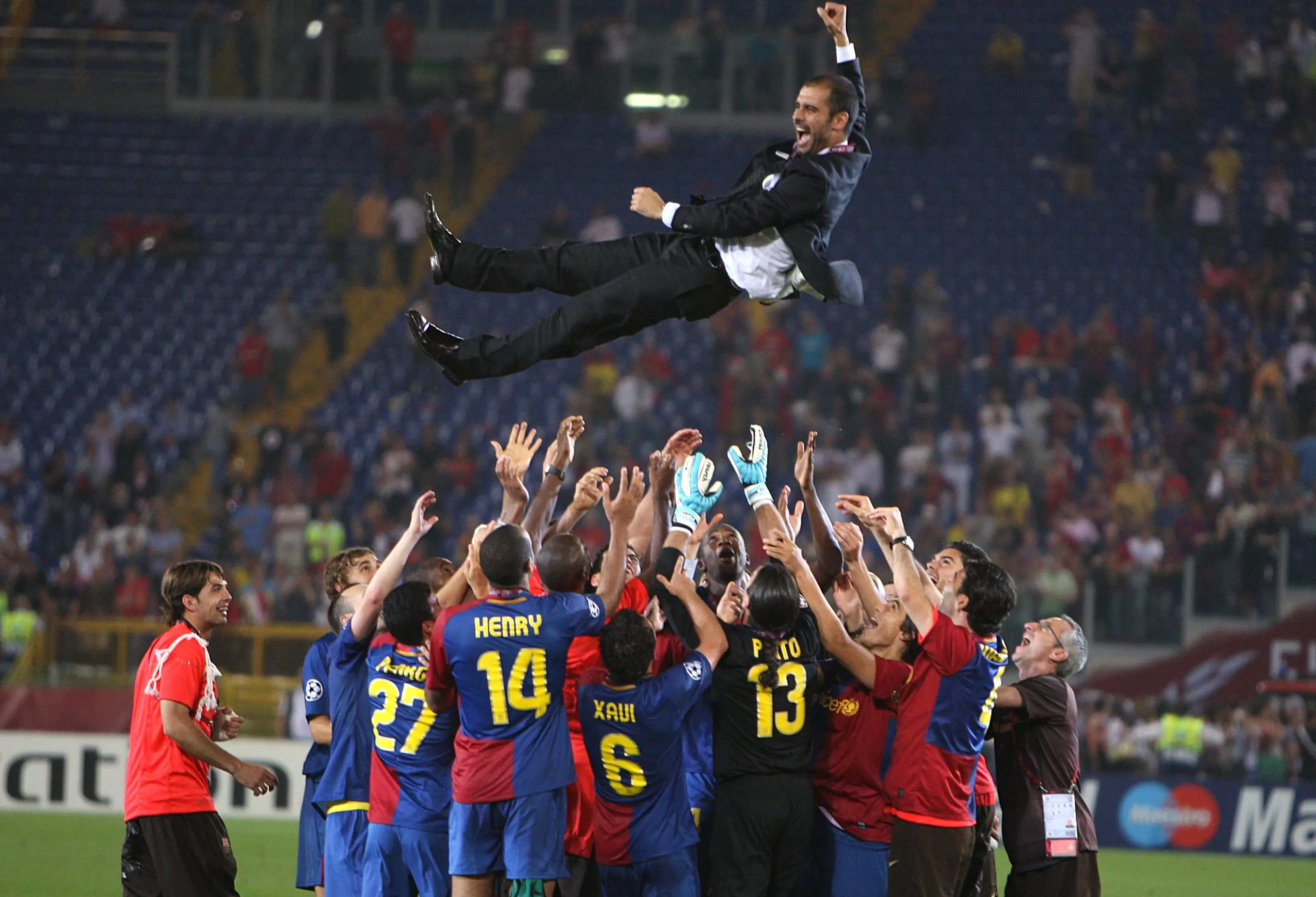 Guardiola is thrown in the air after his first Champions League win as manager. Image: PA Images