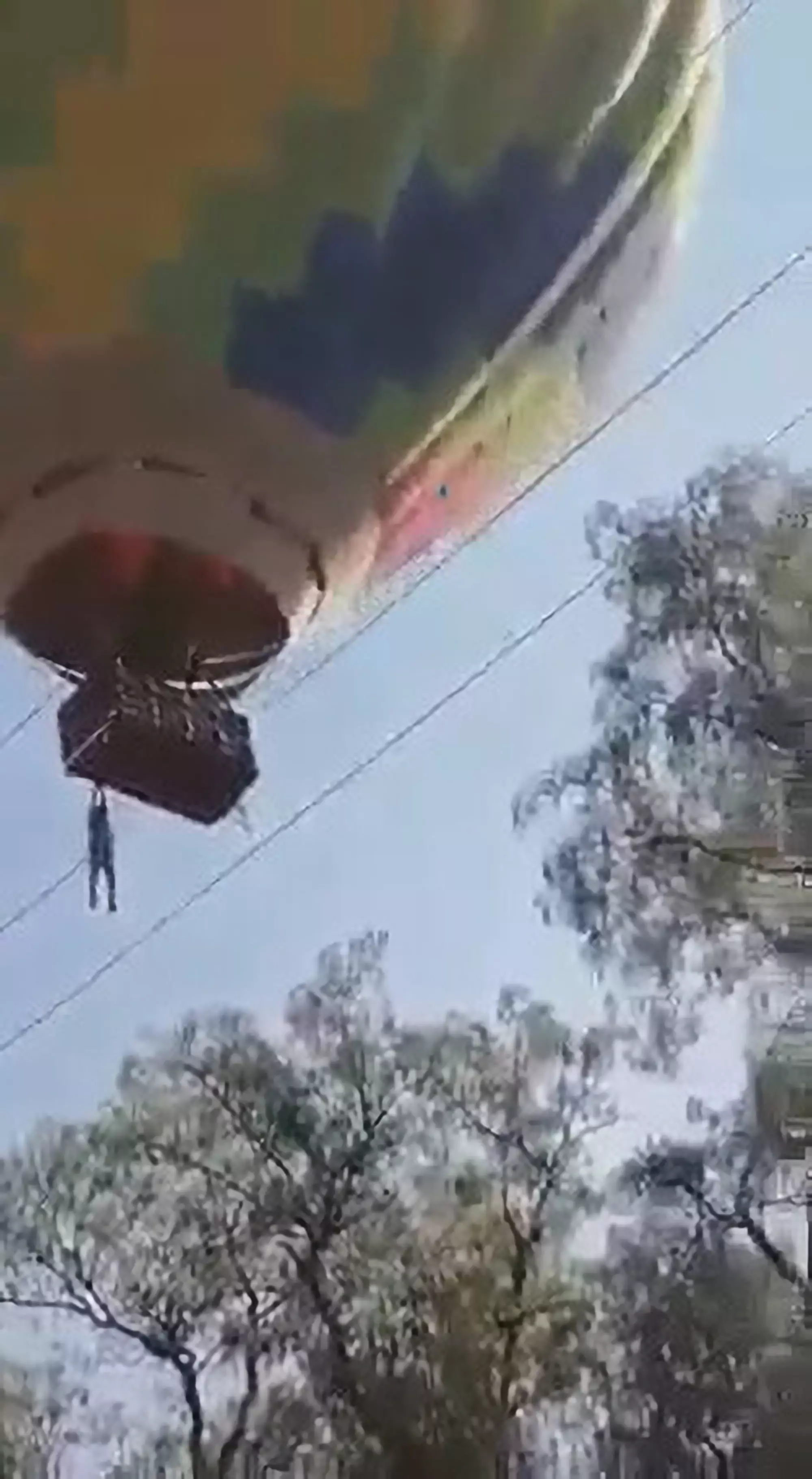 Onlookers urged him to 'hold on' as he hung suspended in the air.