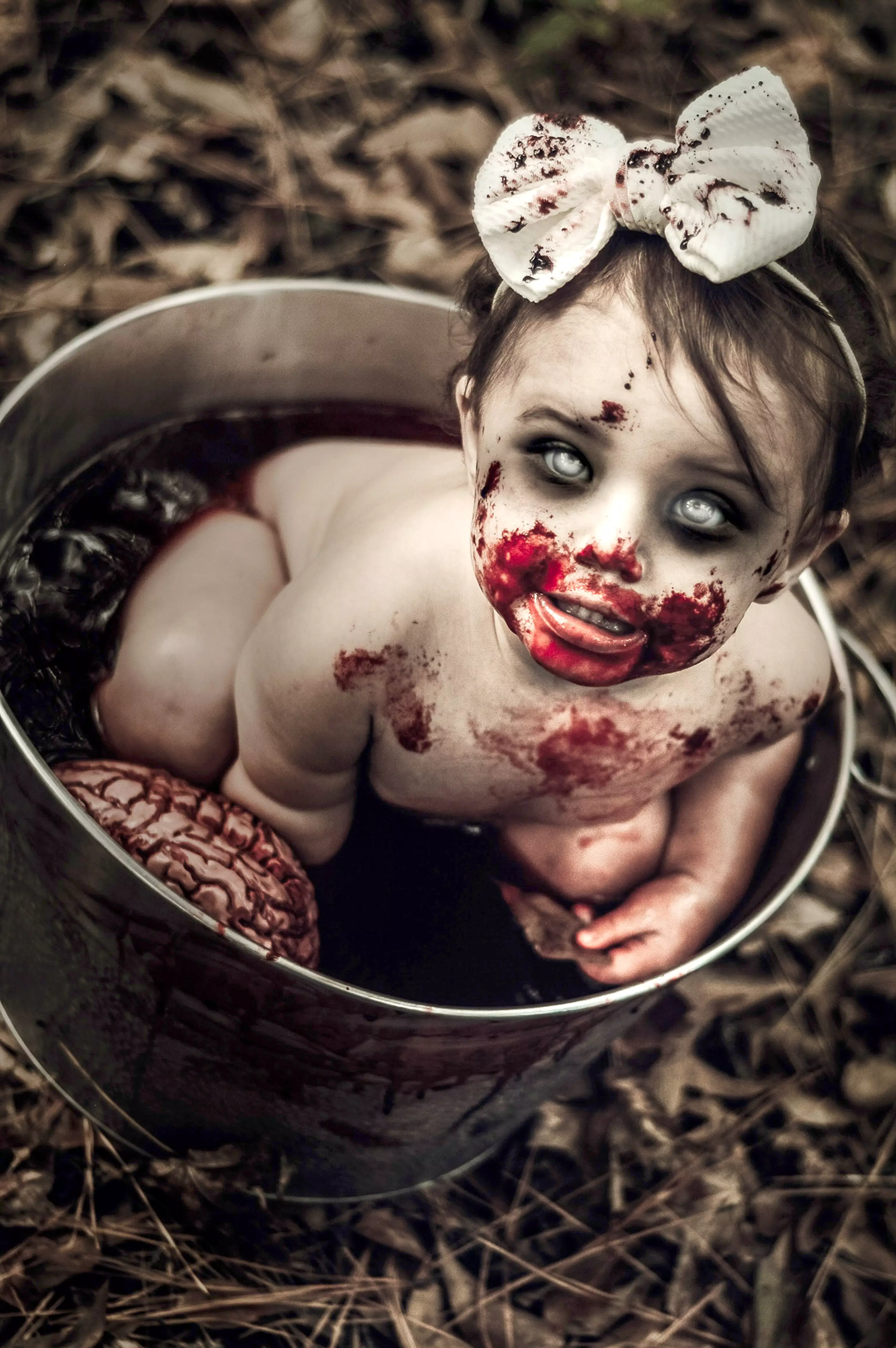 One-year-old Coraline poses in a bucket of fake blood made from jelly and chocolate. (