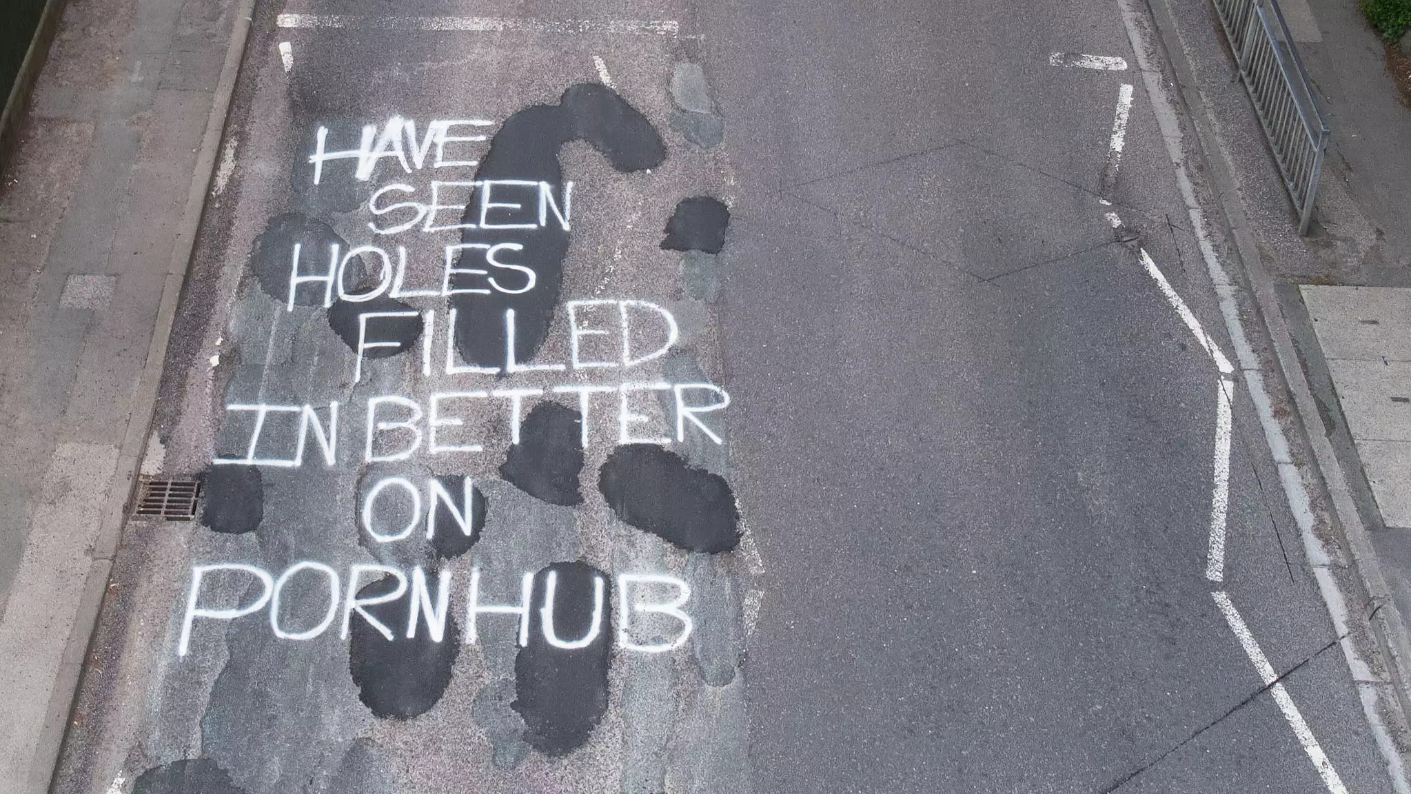 Mystery Graffiti Artist Leaves Message Comparing Road Potholes To Porn Site
