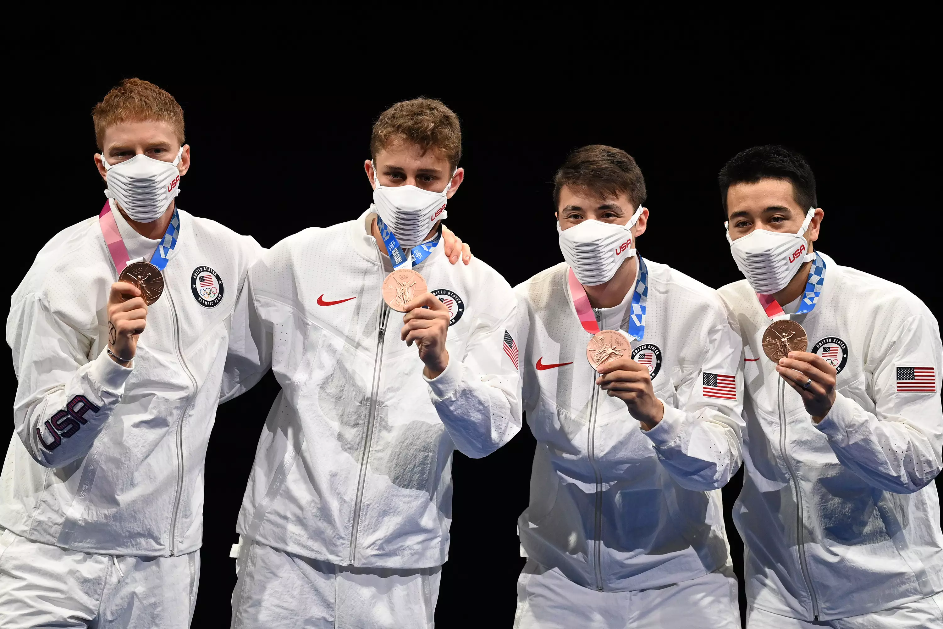 Members of Team USA pose with the bronze medals during the awarding ceremony for the fencing men's foil team event at Tokyo 2020 Olympic Games. (