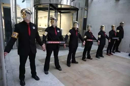 Activists glued themselves to the entrance of the London Stock Exchange.