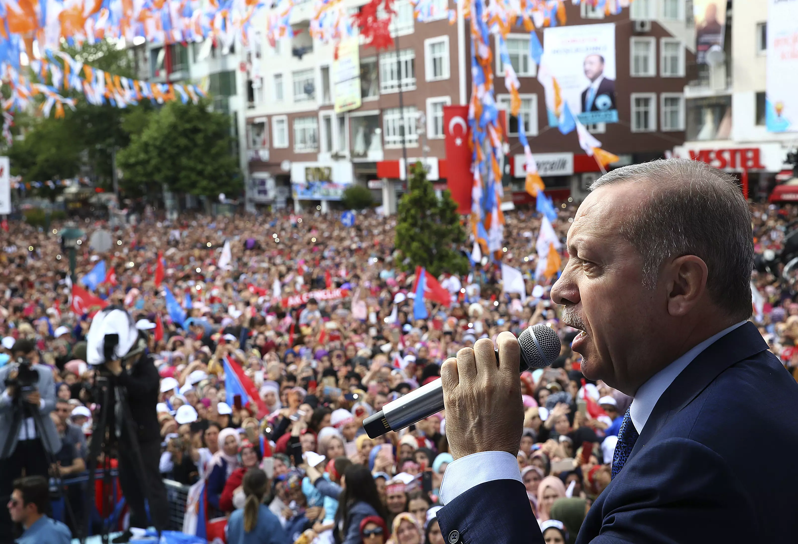 Turkey's President Recep Tayyip Erdogan speaks to people at campaign rally.