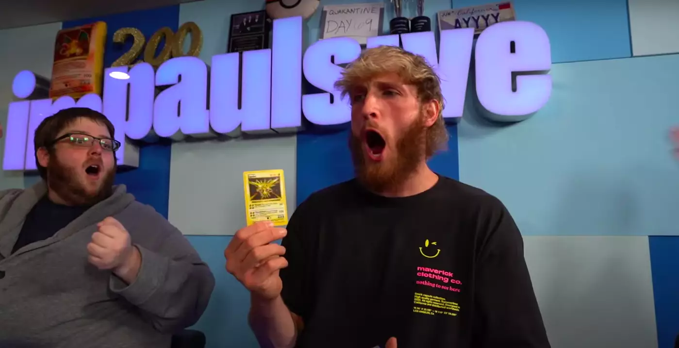Logan Paul with a Pokémon card /