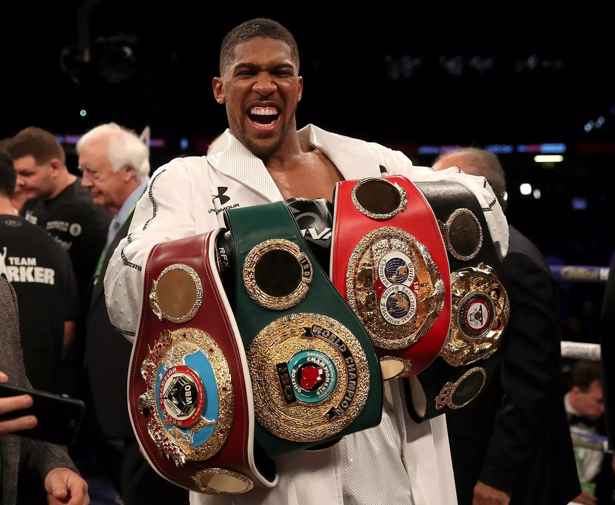 Joshua with his world titles including WBA title. Image: PA