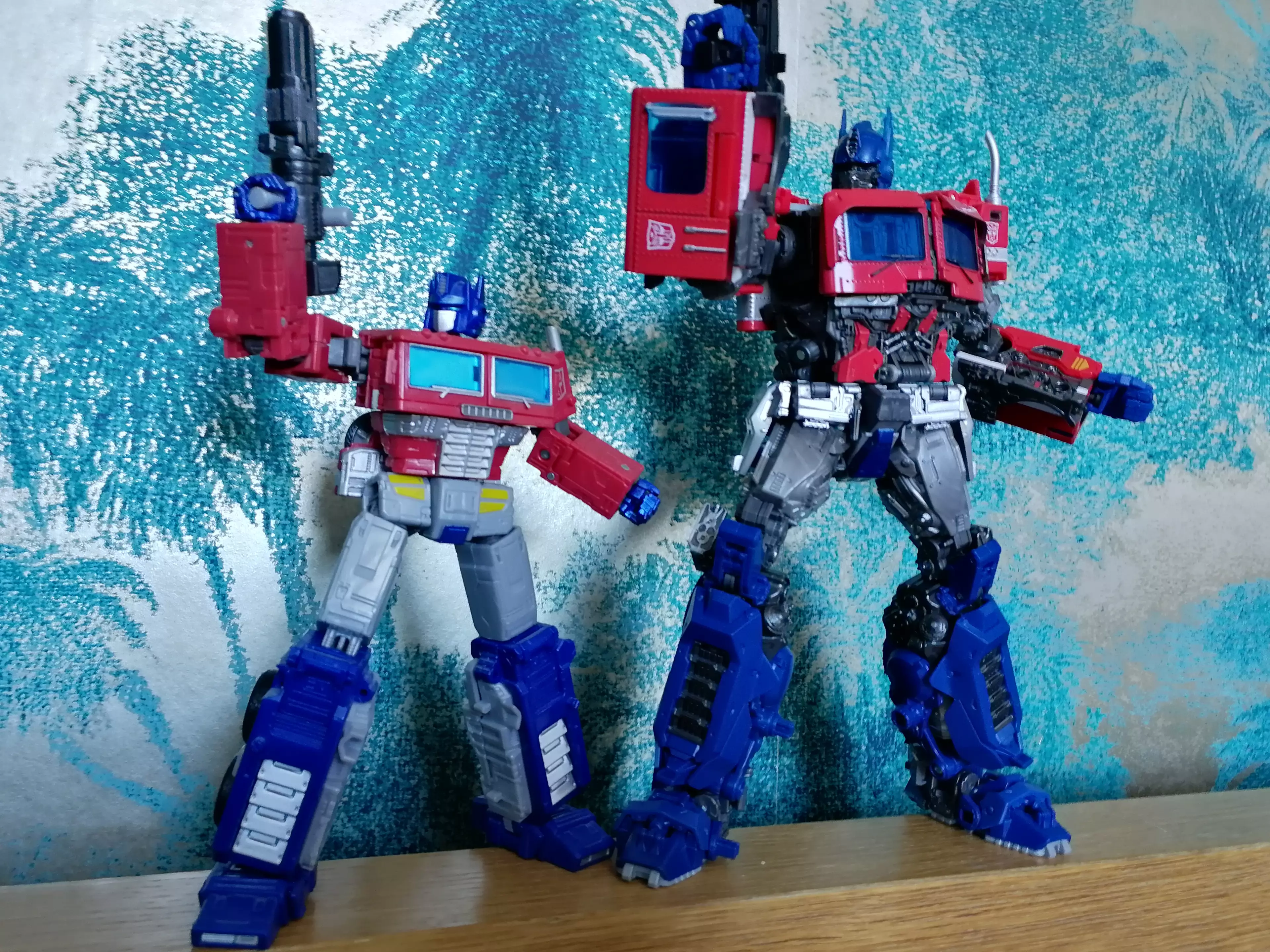 MPM-12 (right) next to Earthrise Optimus Prime, showing off his window-arms / credit: the author