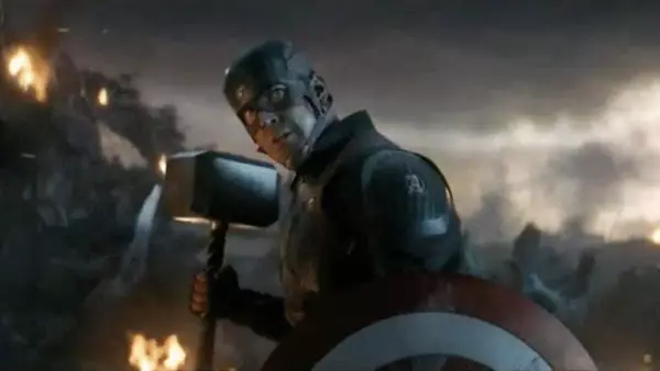 Captain America lifts Thor's hammer.