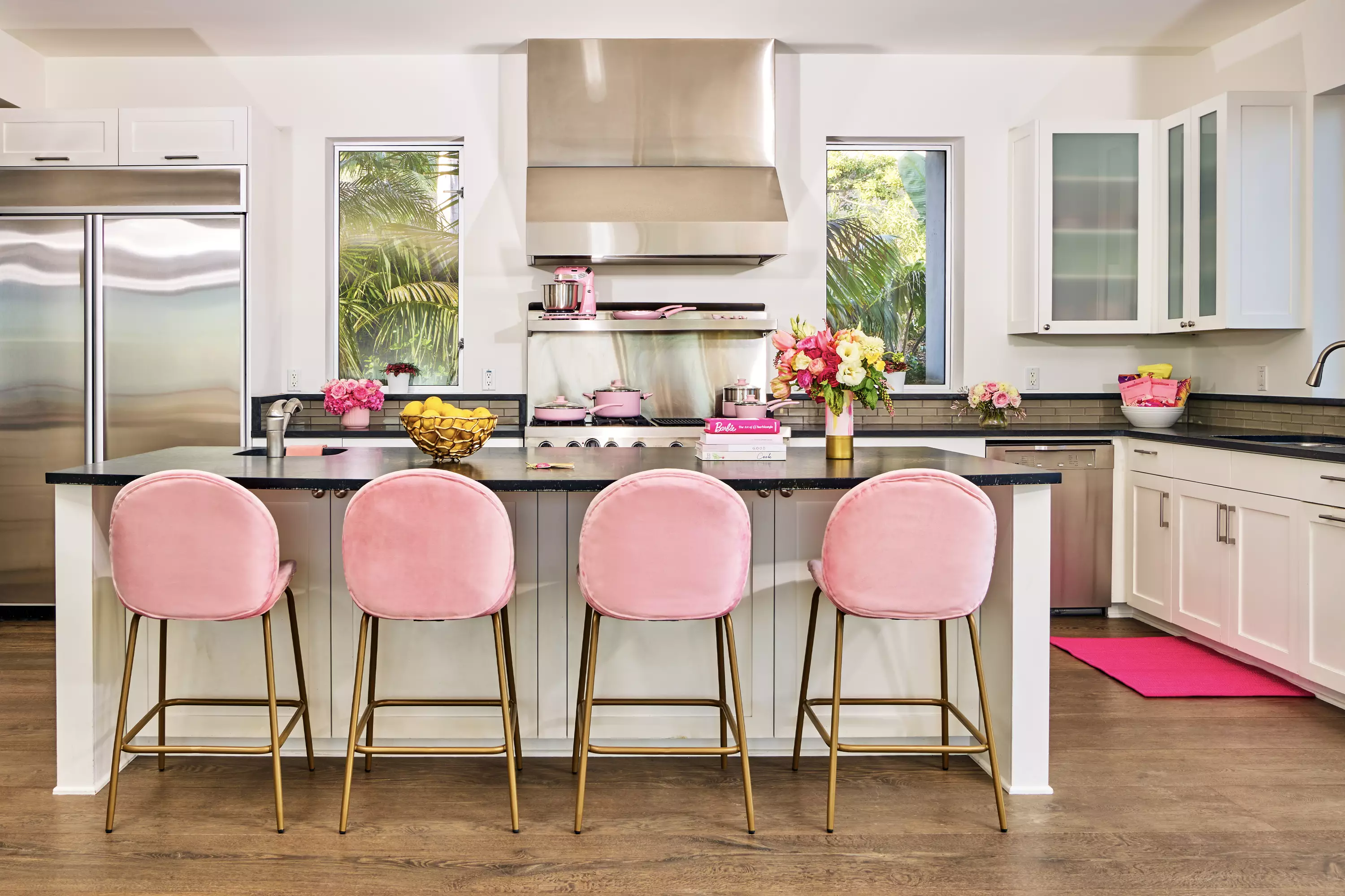 The kitchen features pink accents and velvet pink bar stools, though you won't be doing much cook as there's a private cooking lesson. (