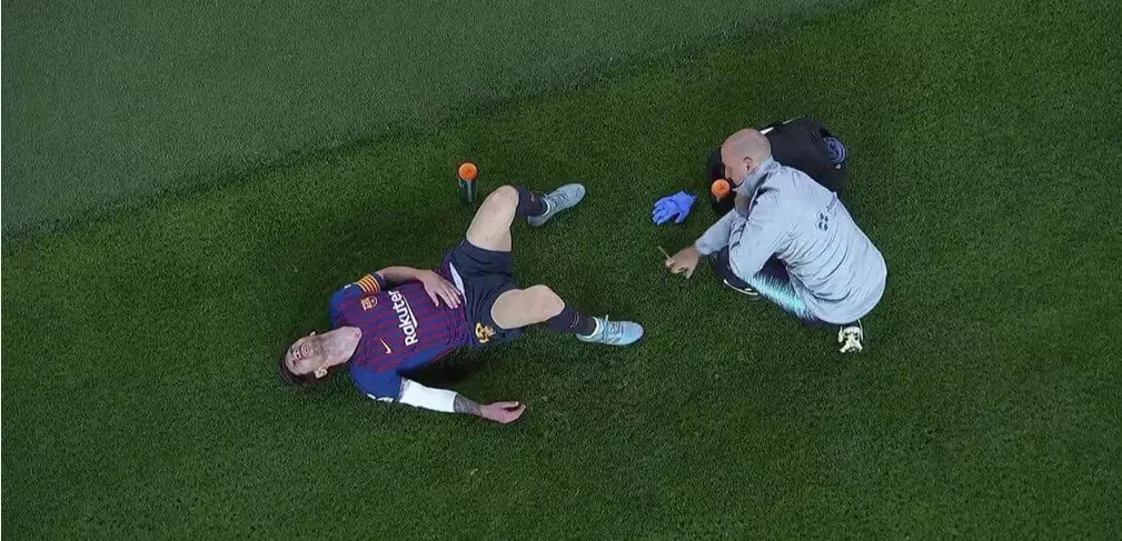 Messi lies on the ground receiving treatment. Image: Eleven Sports