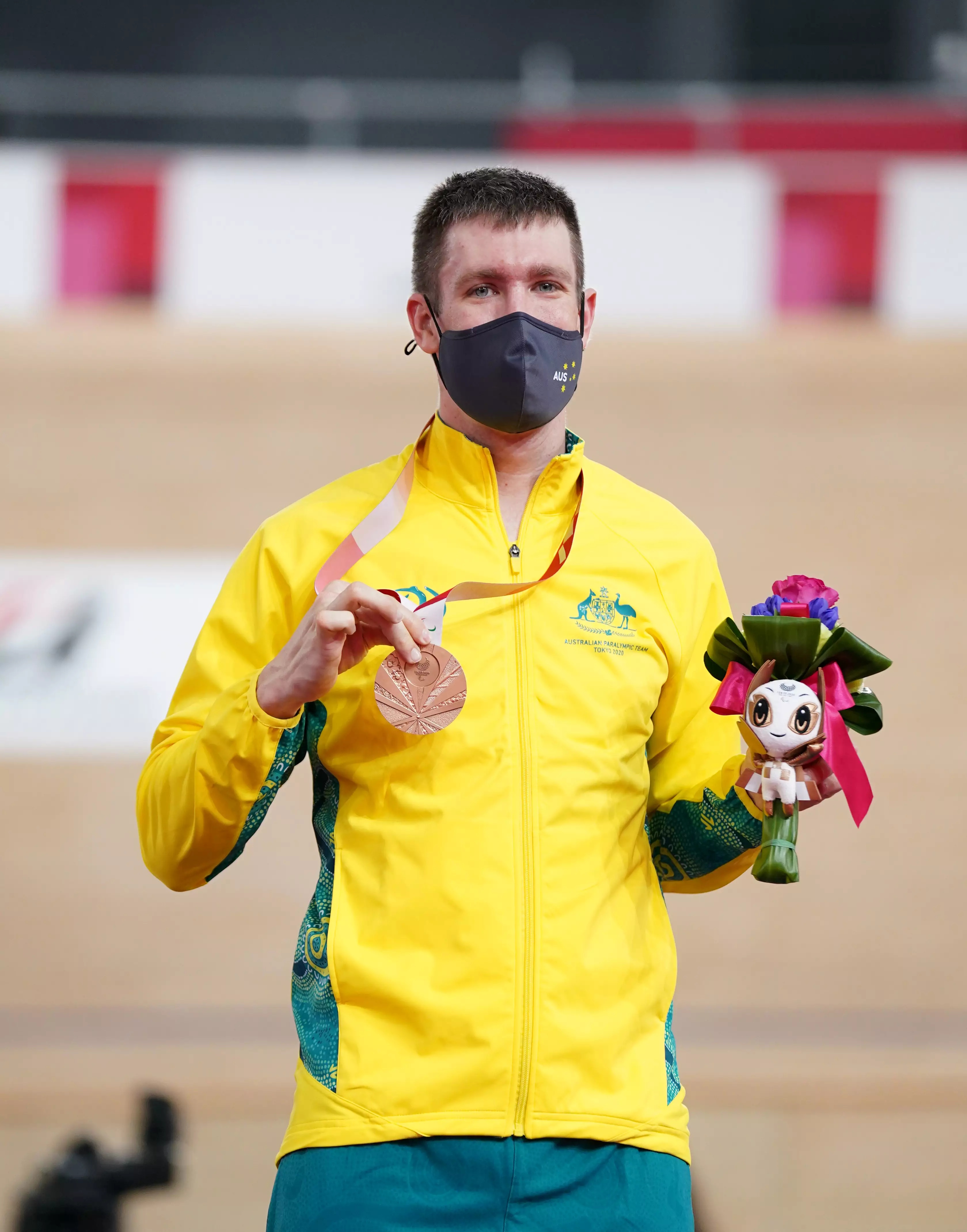 Australia's Darren Hicks celebrates with his silver medal after finishing second in the Men's C2 3000 metres Individual Pursuit.