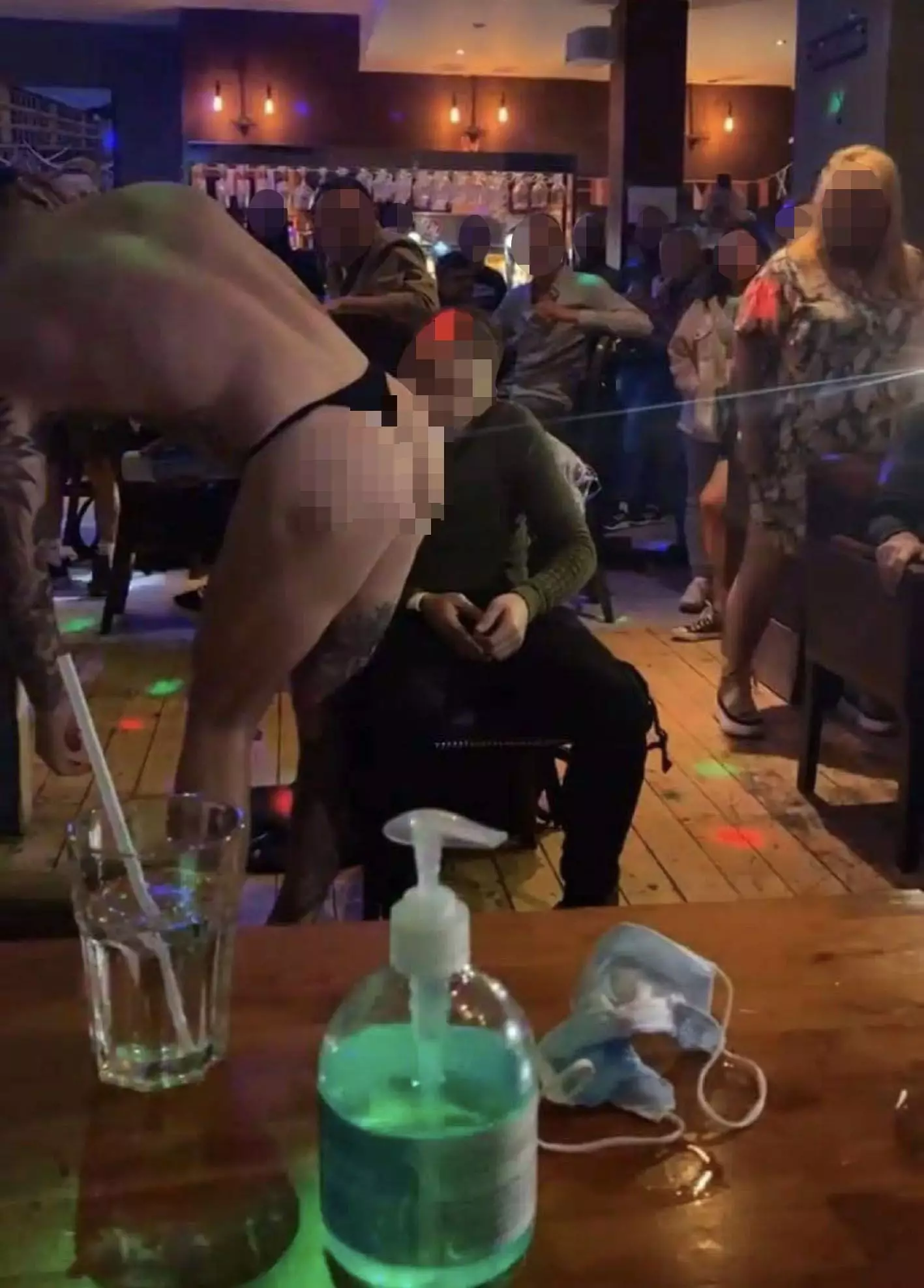 A punter was pictured licking whipped cream off a stripper's bum.