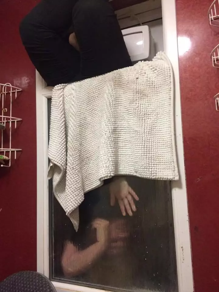 Woman stuck in window