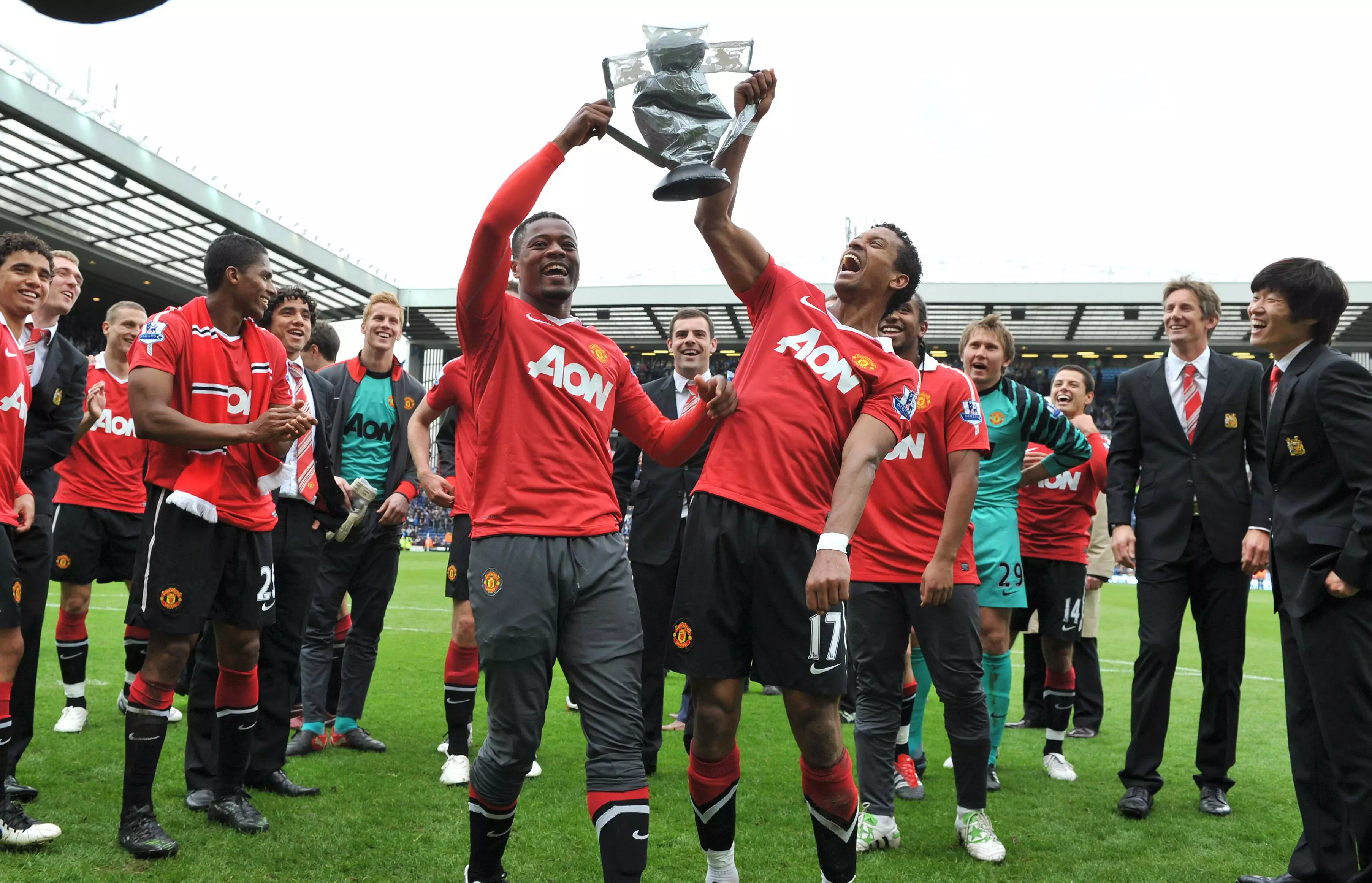 Evra celebrates with Nani and a fake Premier League trophy after the draw with Blackburn. Image: PA Images