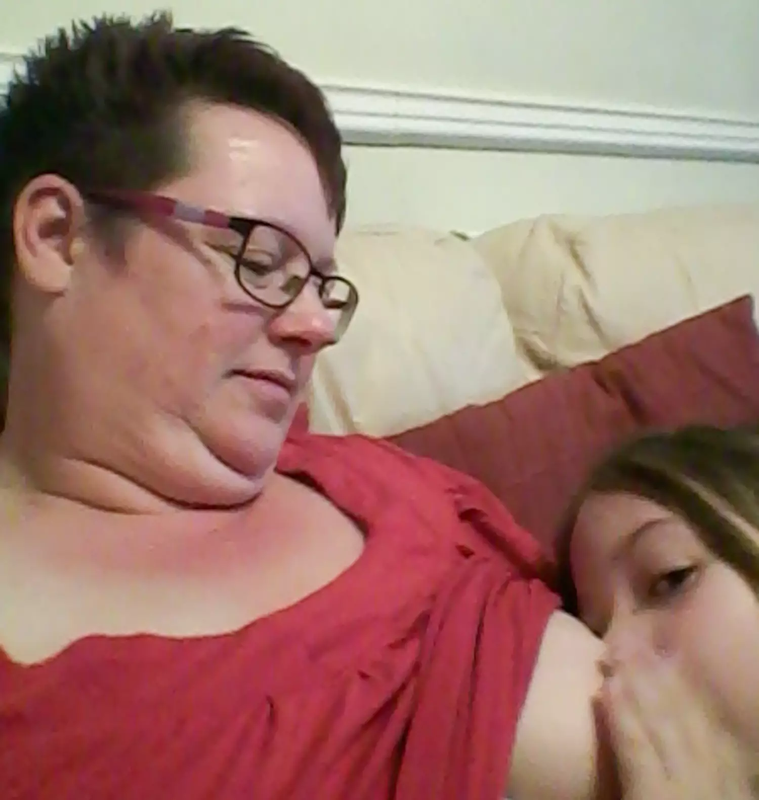 Mum breastfeeds her nine-year-old daughter.