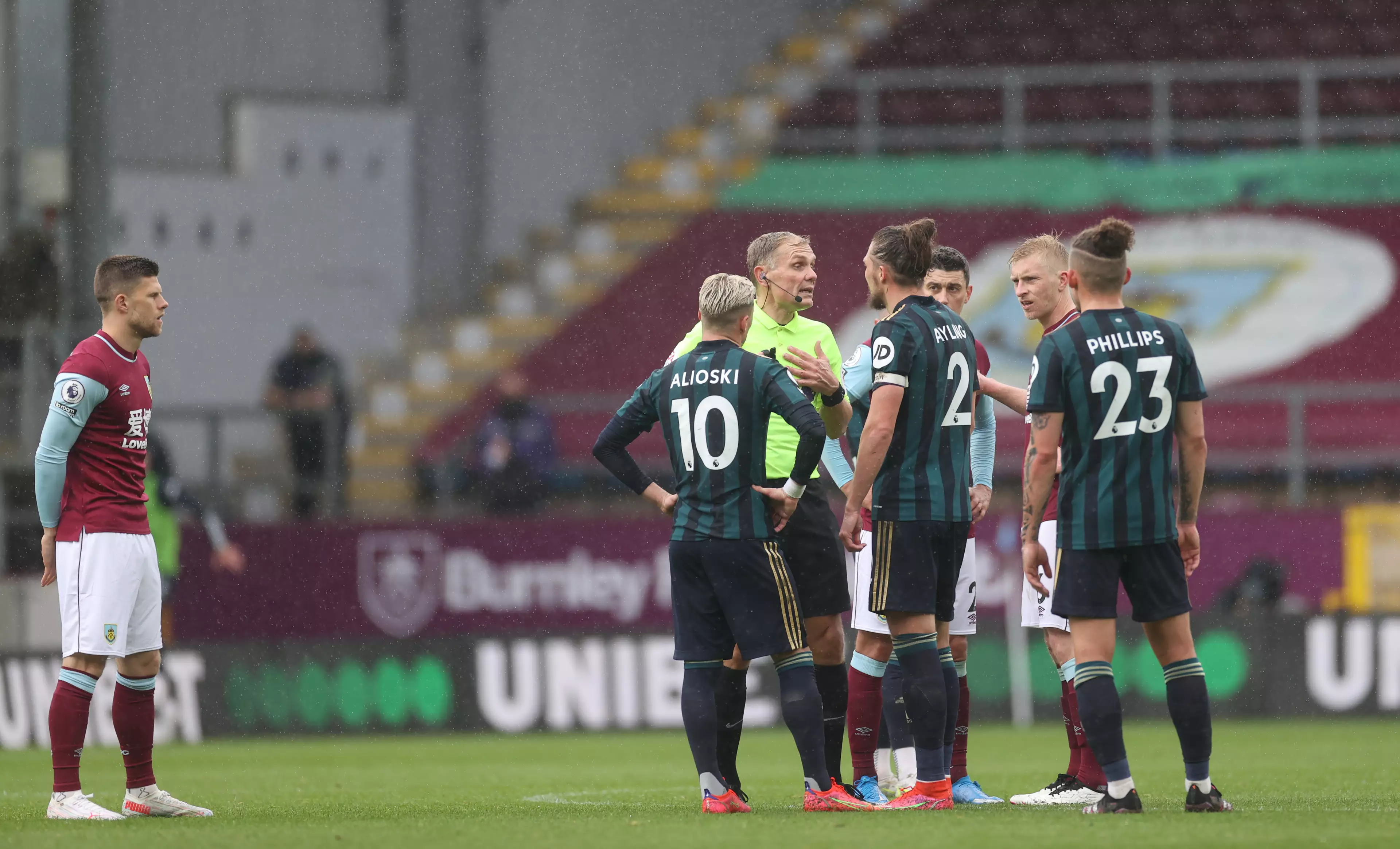 The referee speaks to Alioski and captain Luke Ayling during the game. Image: PA Images
