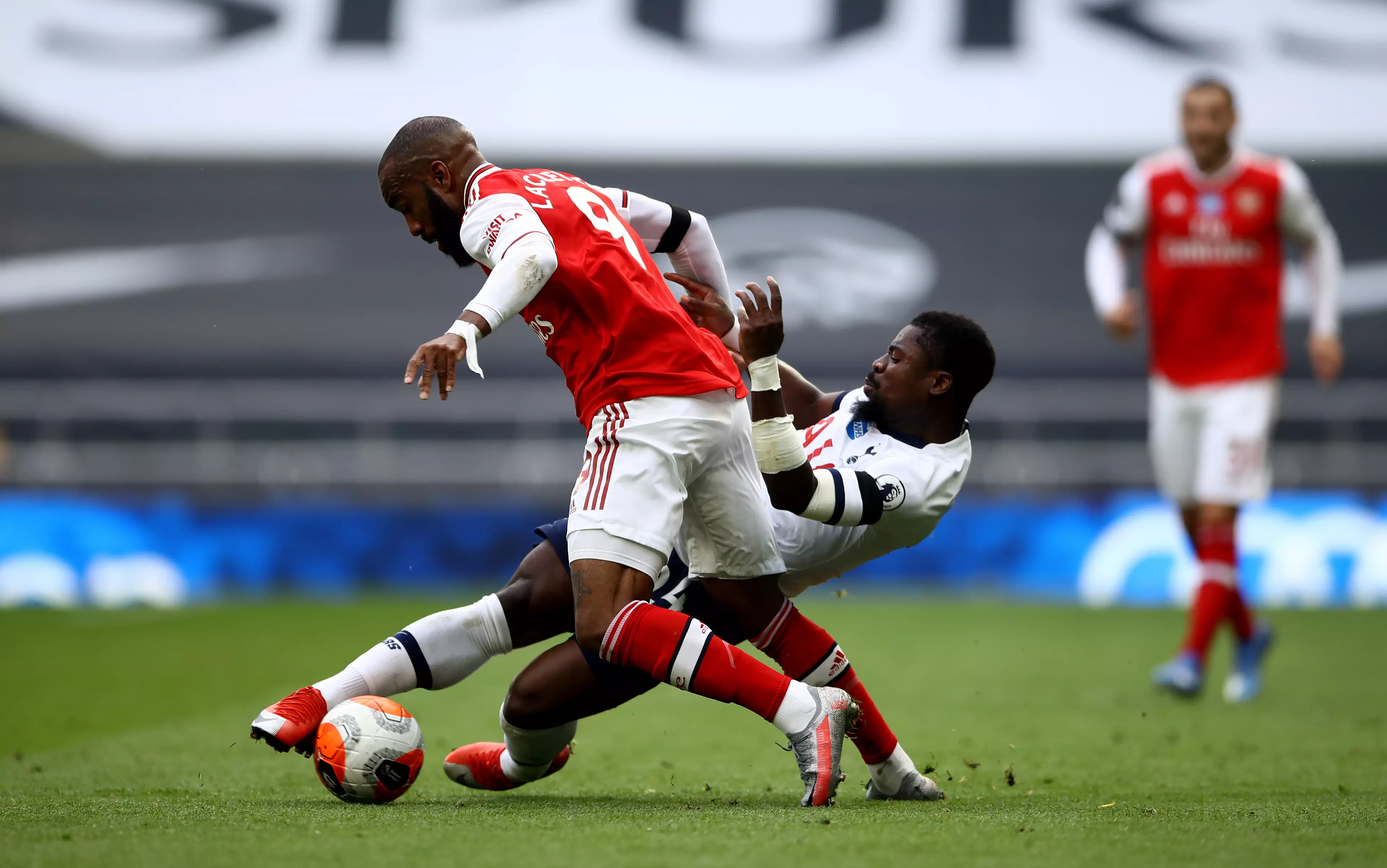Aurier, winning a tackle on Alexandre Lacazette, played in Sunday's north London derby. Image: PA Images