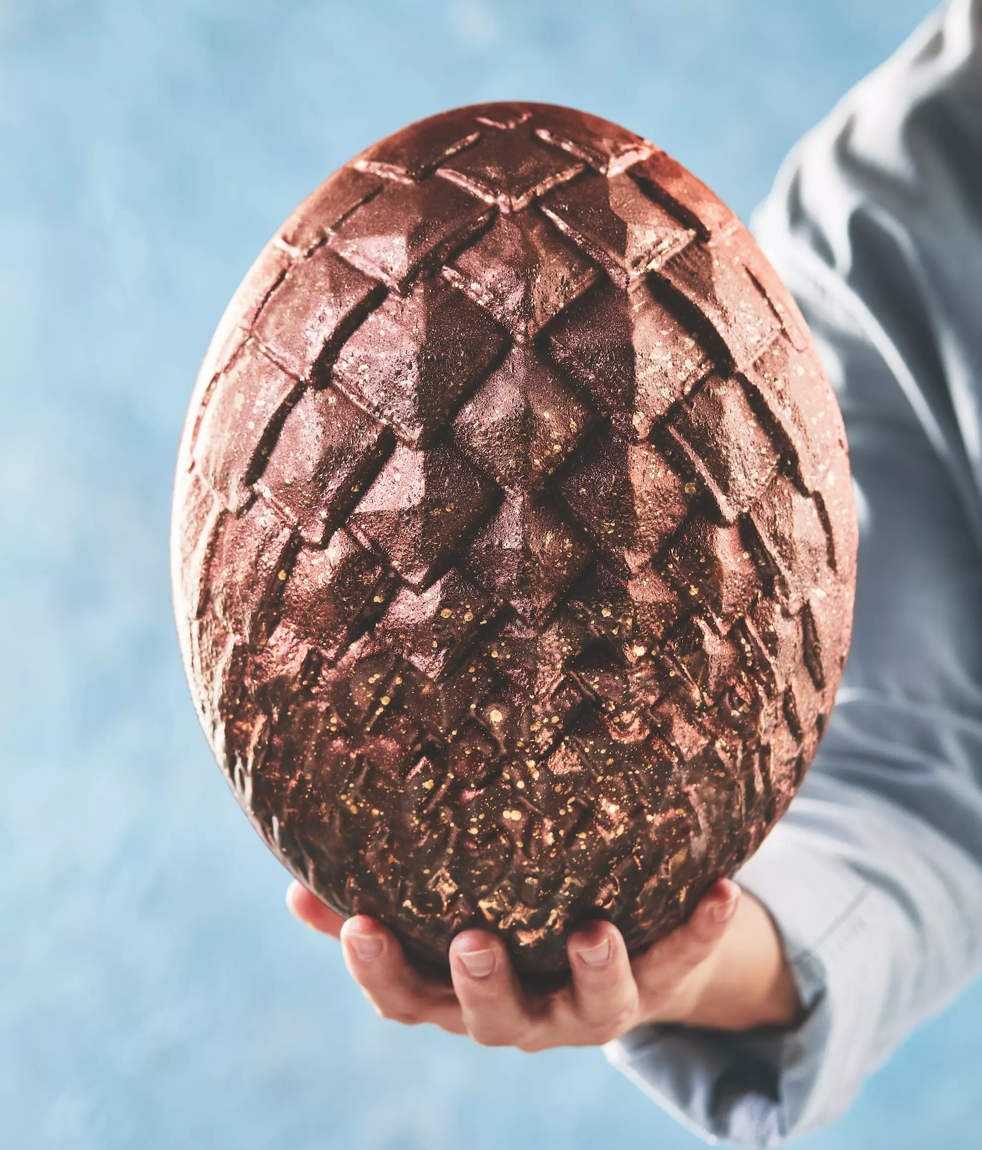 This milk chocolate dragon egg has been finished with metallic ombre (