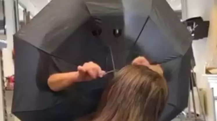 Hairdresser Cuts Holes In Umbrella To Create Barrier Between Clients