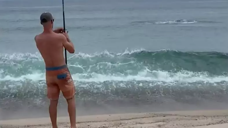Man Hooks A Great White Shark While Fishing On The Beach