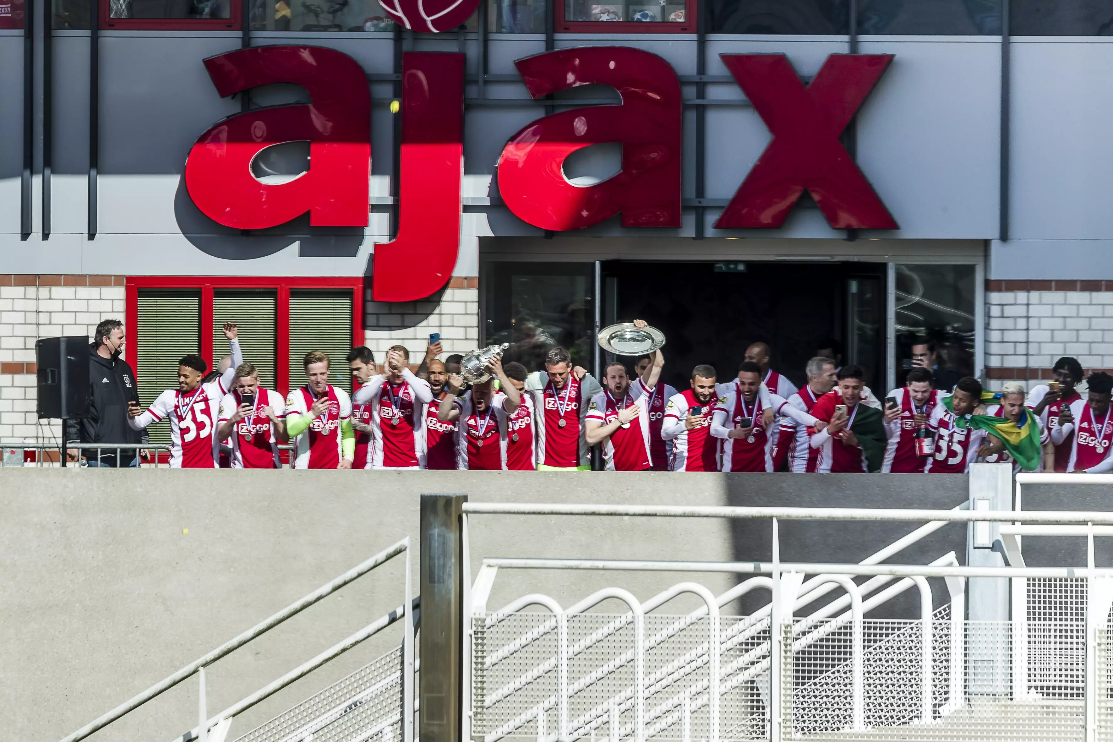 Ajax players stand on the balcony at the stadium to celebrate with the fans below. Image: PA Images