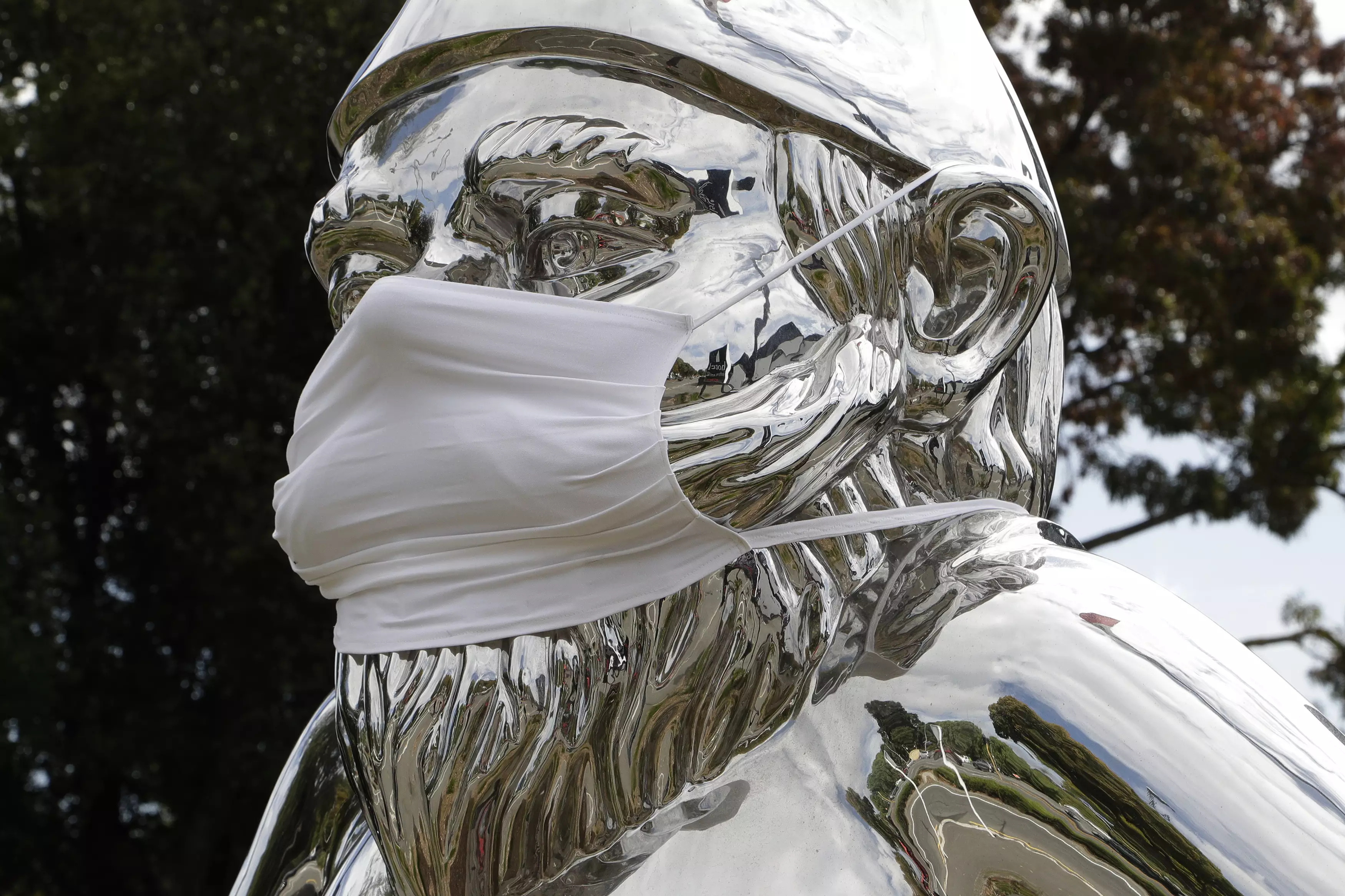 A mask draped over a statue in Christchurch.