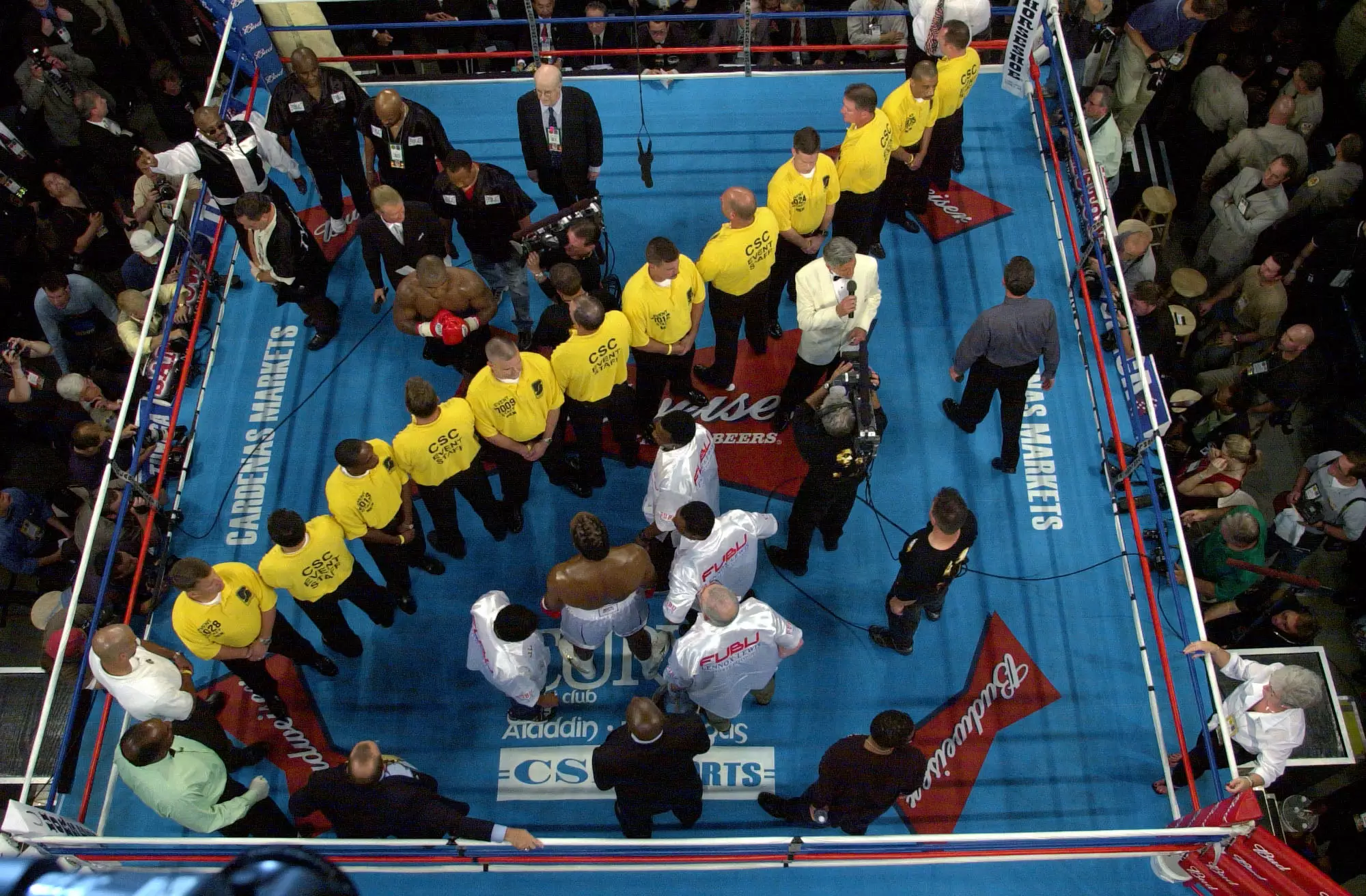 A line of security separates Tyson and Lewis in the ring before their heavyweight championship fight. Image: PA