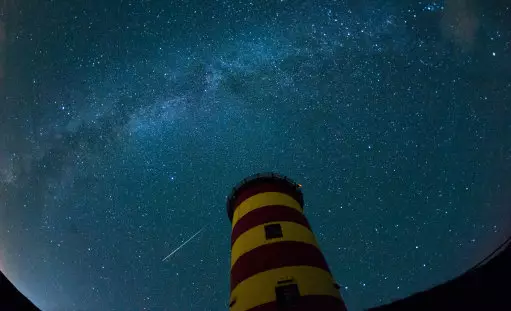 A shooting star lights up the night sky above the Pilsum lighthouse in Pilsum, Germany, 12 August 2015.
