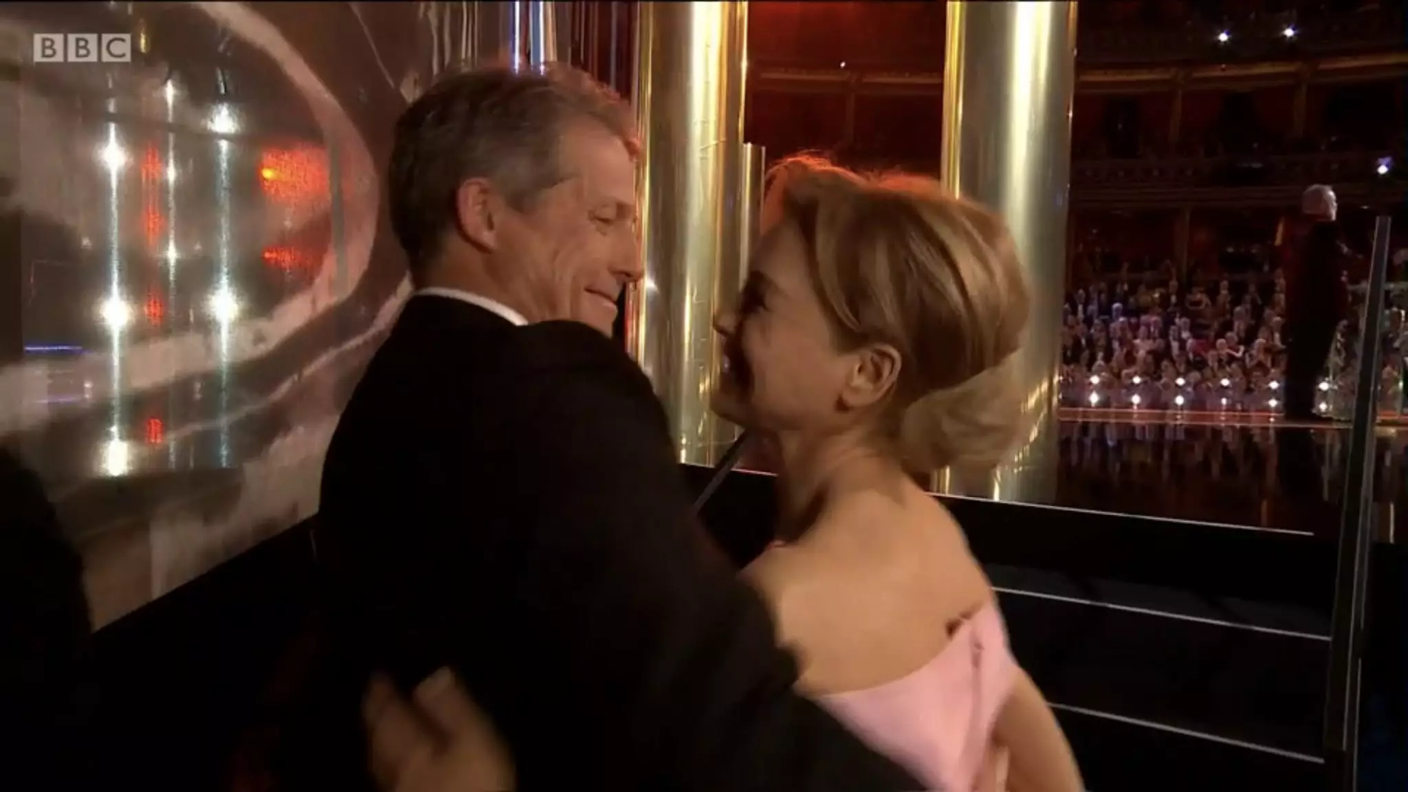Hugh Grant greeted Renee Zellweger at the side of the stage (