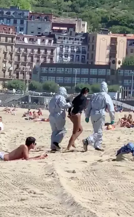 Officers in hazmat suits removed her from the beach.