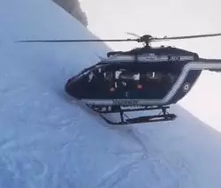 The helicopter landed with the blades scarily close to the mountainside.