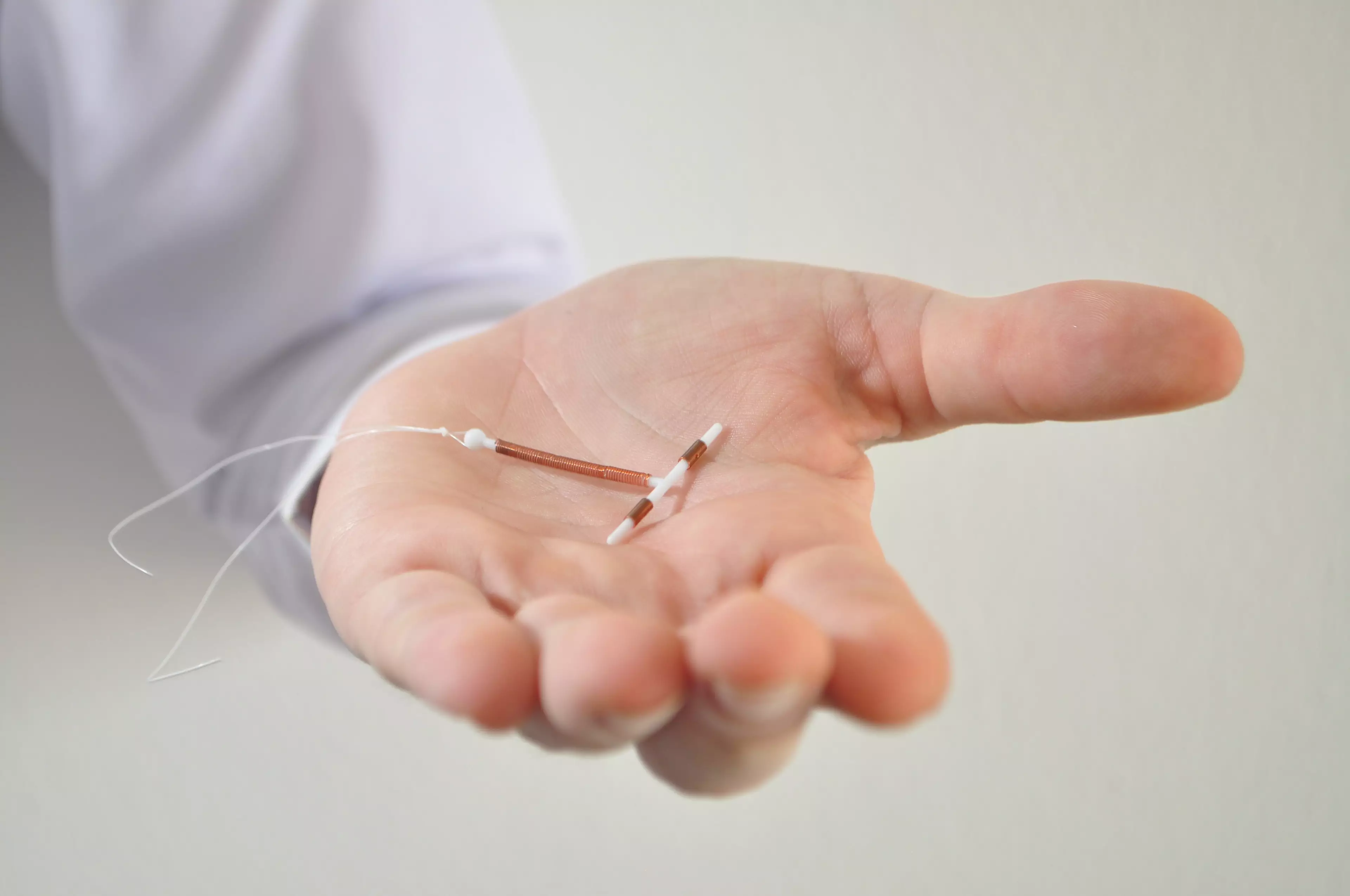 An IUD is a small T-shaped device made from plastic and copper that is inserted into the uterus (