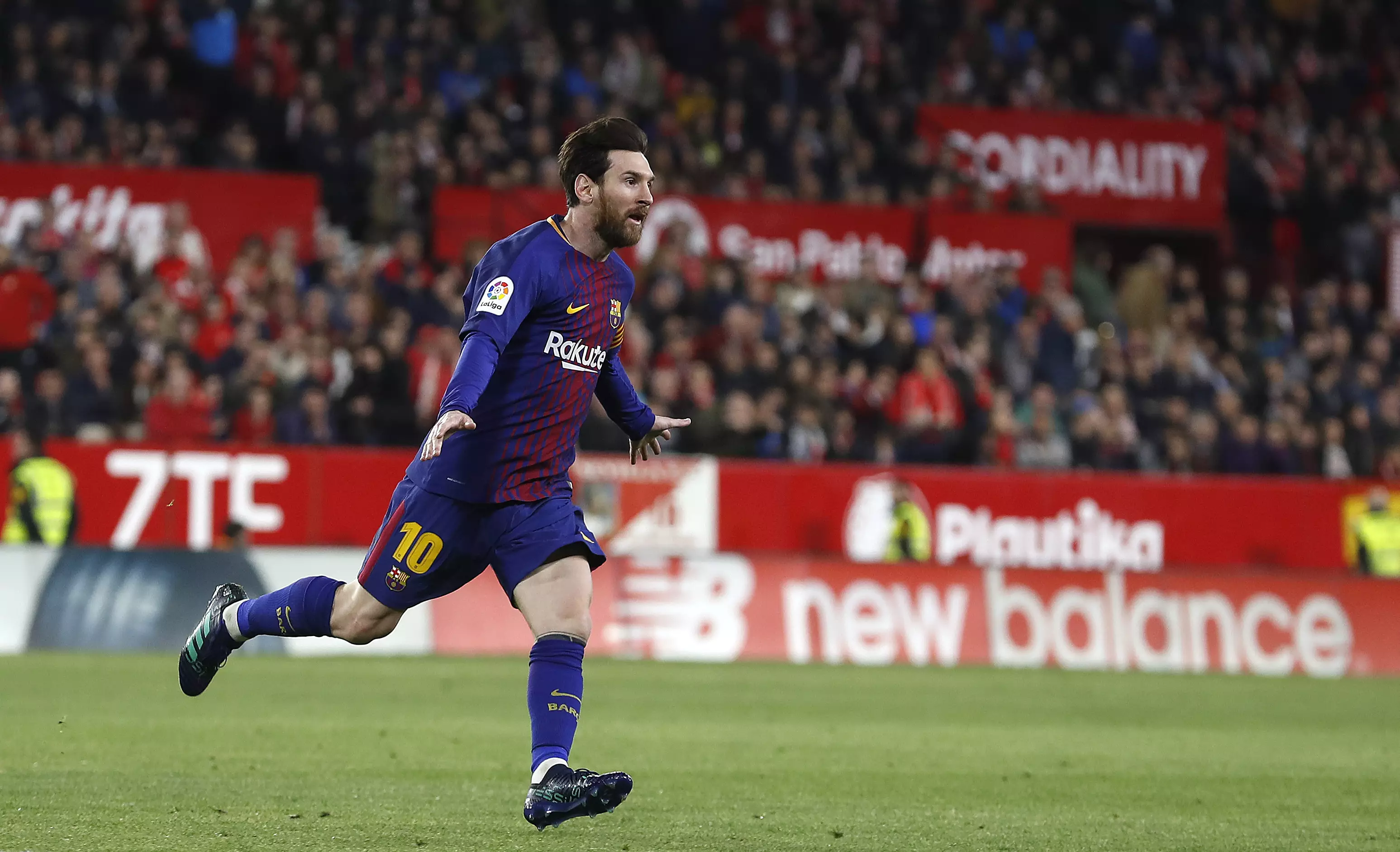 Messi celebrates scoring against Sevilla. Image: PA
