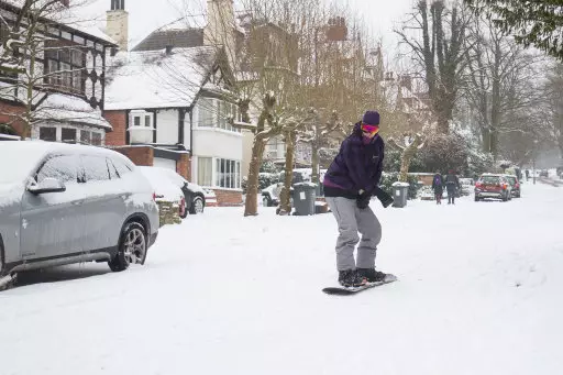 George Sachl snowboards down Park Hill, in Birmingham as snow and sub-zero conditions blighted Britain's roads.