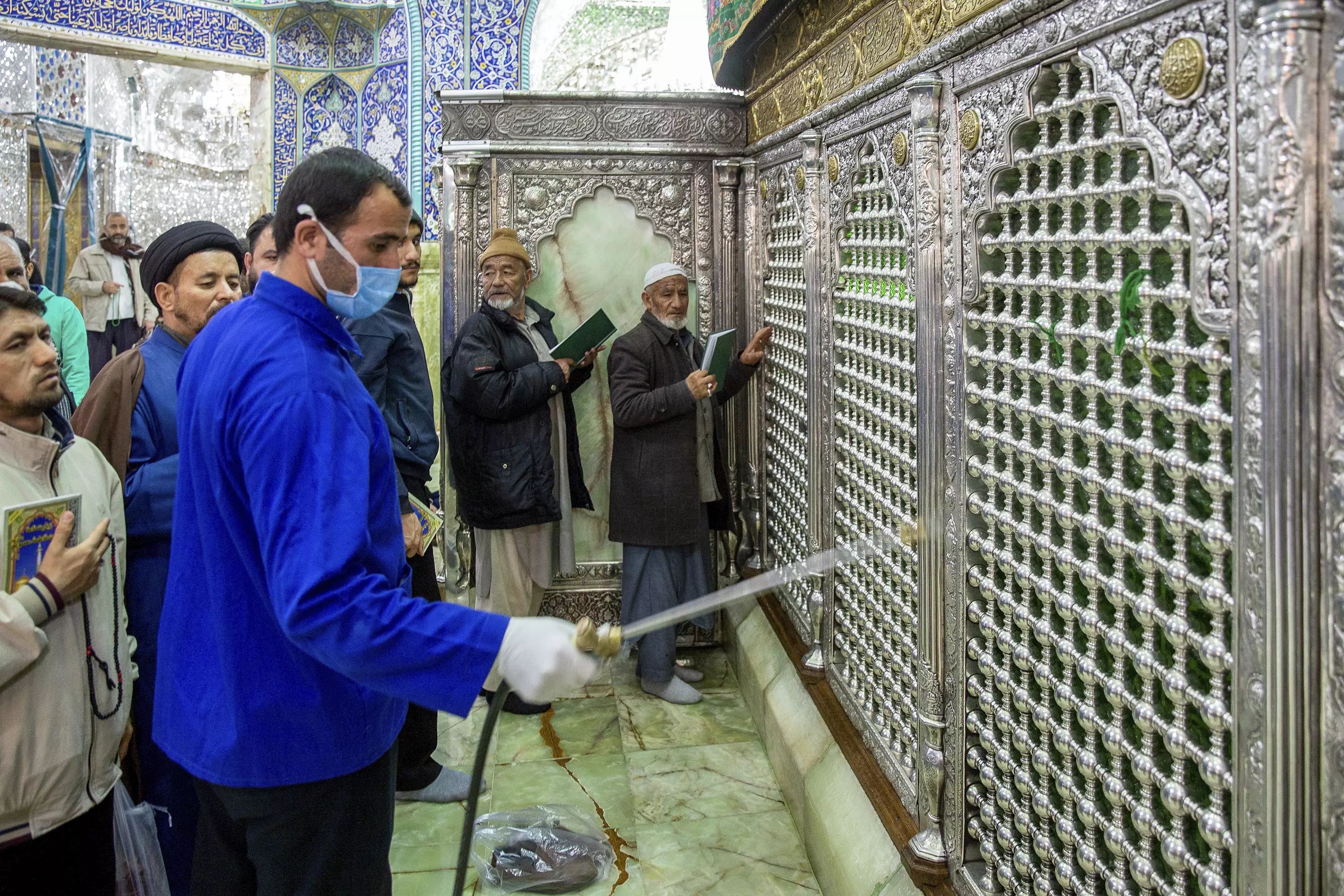 A man disinfects the shrine of Saint Masoumeh against coronavirus in the city of Qom.