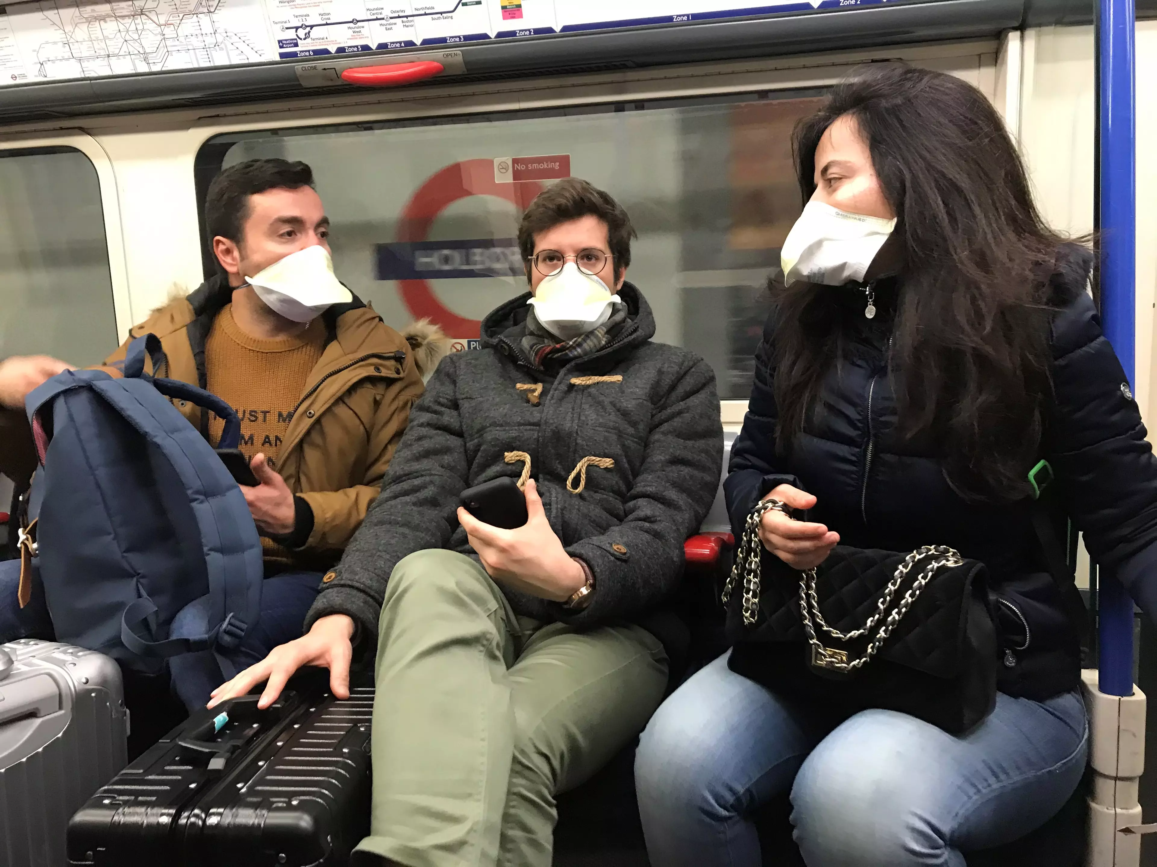 People wearing face masks on the London Underground.