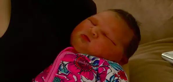 A mum has likened her newborn daughter to a 'sumo wrestler' after she was born at almost 13lbs