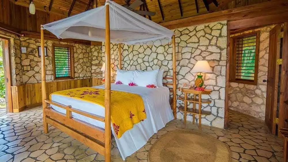 Sleep in a four poster bed below a netted canopy (Rockhouse Resort & Spa)