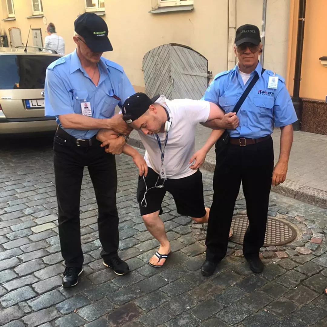 One of Ainars' posts shows him collapsed in the arms of security guards.