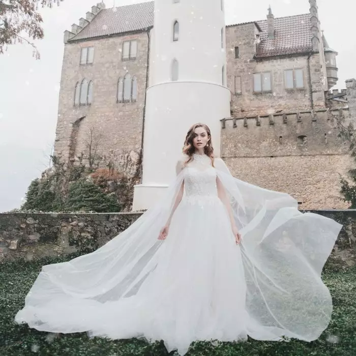 One of Princess Aurora's gowns features a diaphanous, lace detailed bridal cape (
