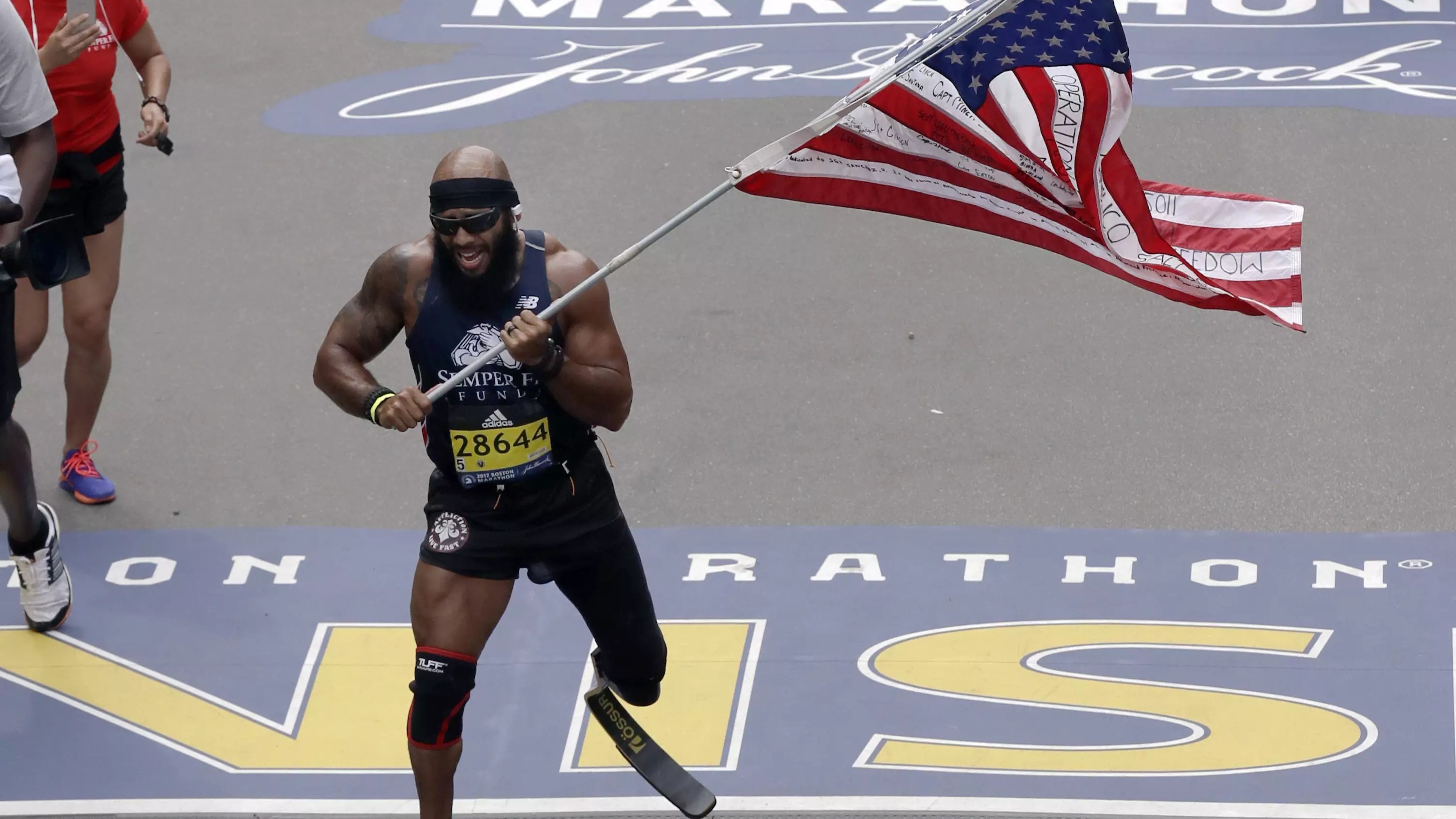 Amputee Marine Completes The Boston Marathon With Massive American Flag