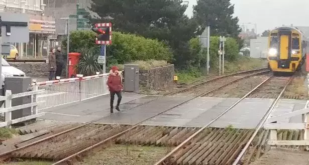 The woman crossed the tracks ignoring any warning.