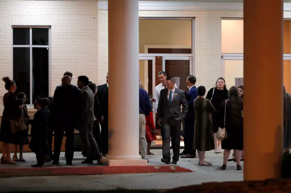Pastor Tony Spell, center background, talks to congregants after an evening service at Life Tabernacle Church in Central, Louisiana, on 31 March.