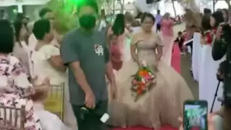 Man Hides Under Bride's Wedding Dress to Help Her Walk Amid Strong Winds