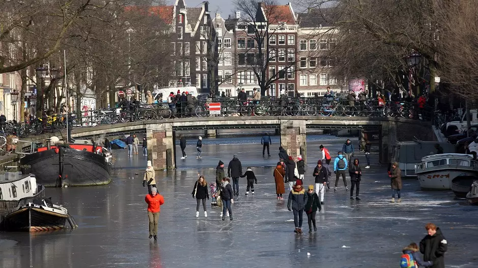 Families Take To Amsterdam's Frozen Canals For Ice Skating