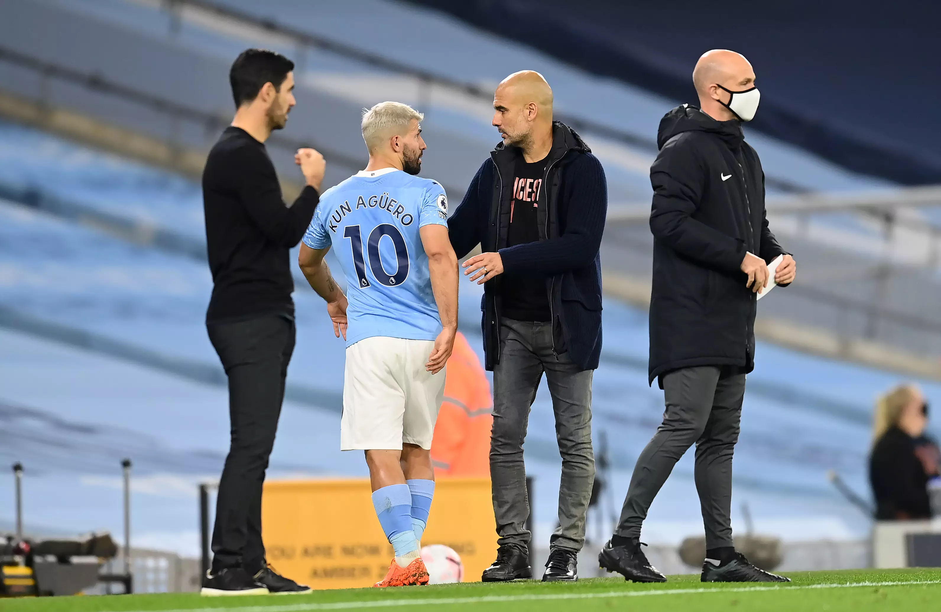 Guardiola talking to Aguero after substituting him off. Image: PA Images