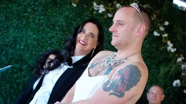 Couple Swap Wedding Roles As Groom Walks Down Aisle In Dress To Bride In Tuxedo