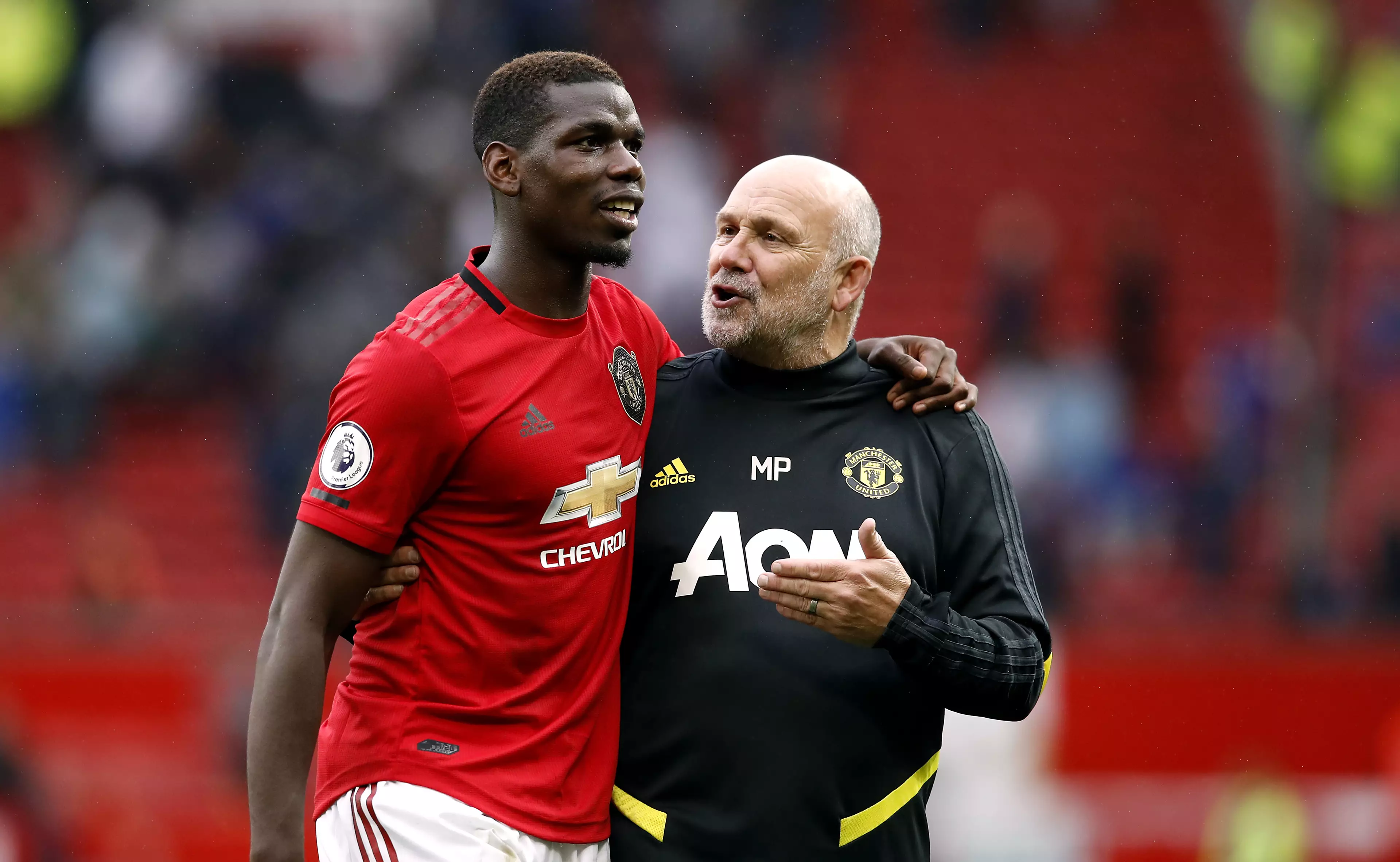 Paul Pogba and Manchester United's assistant manager Mike Phelan.